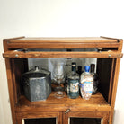 Alternative view of the vintage teak drinks cabinet, its glazed top section with a flipper door, 40cm high and 60cm wide