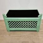 Vintage teak planter painted pistachio green, with cast iron fretwork across the front, 76 cm in length