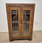 Restored vintage teak cabinet in Art Deco style, with geometric woodwork on the glass doors and brass handles.