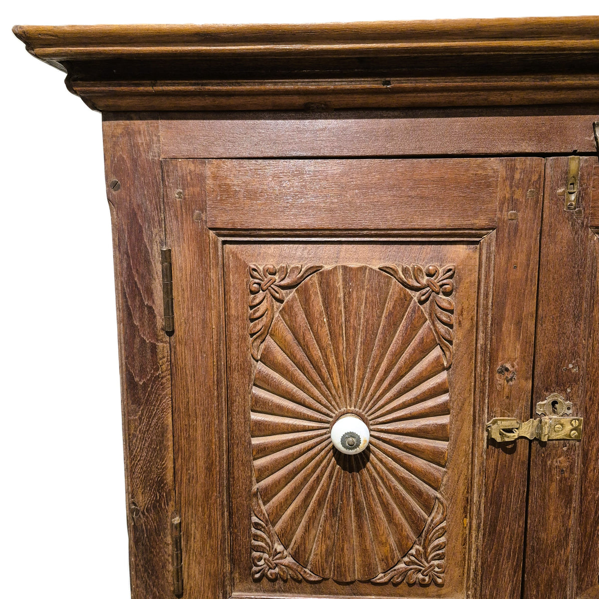 Carved sunburst doors on a vintage teak cabinet, with a whitewashed interior and a shelf in each half
