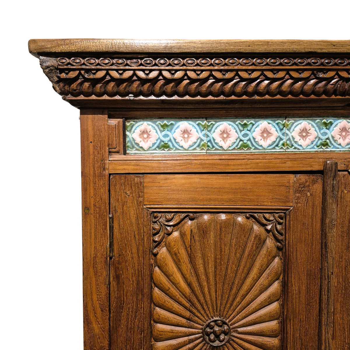 Two door vintage teak cabinet with elaborate sunburst carving at the top and bottom, and ceramic knobs