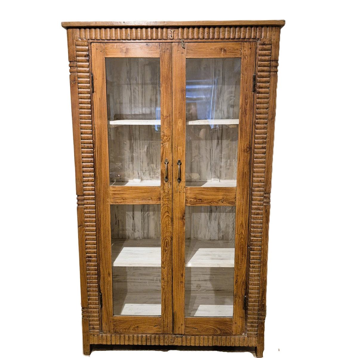 Vintage teak cabinet with glass doors and a hand carved fluted edge, 183 cm high and 108 cm wide, India
