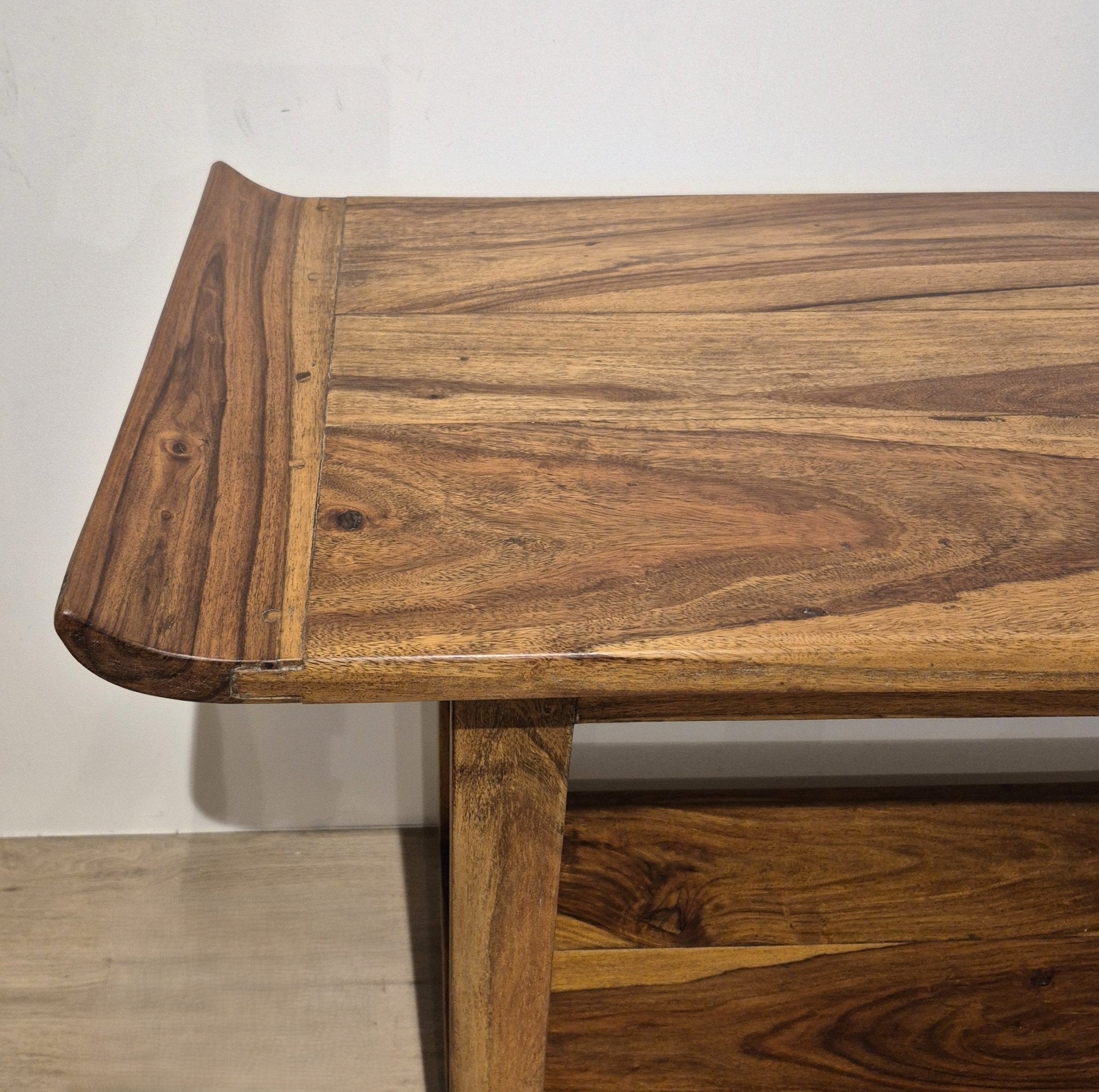 Vintage teak console with a curved edge sweeping upwards along the top, and a useful shelf underneath