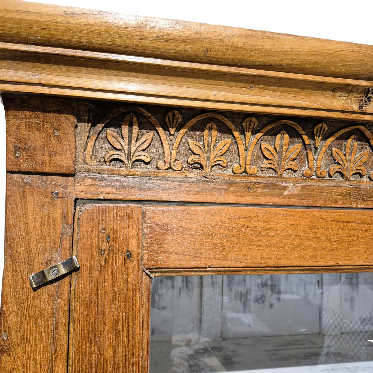 Vintage teak cabinet in a natural wax finish, glass doors above a deep full width drawer, made in India