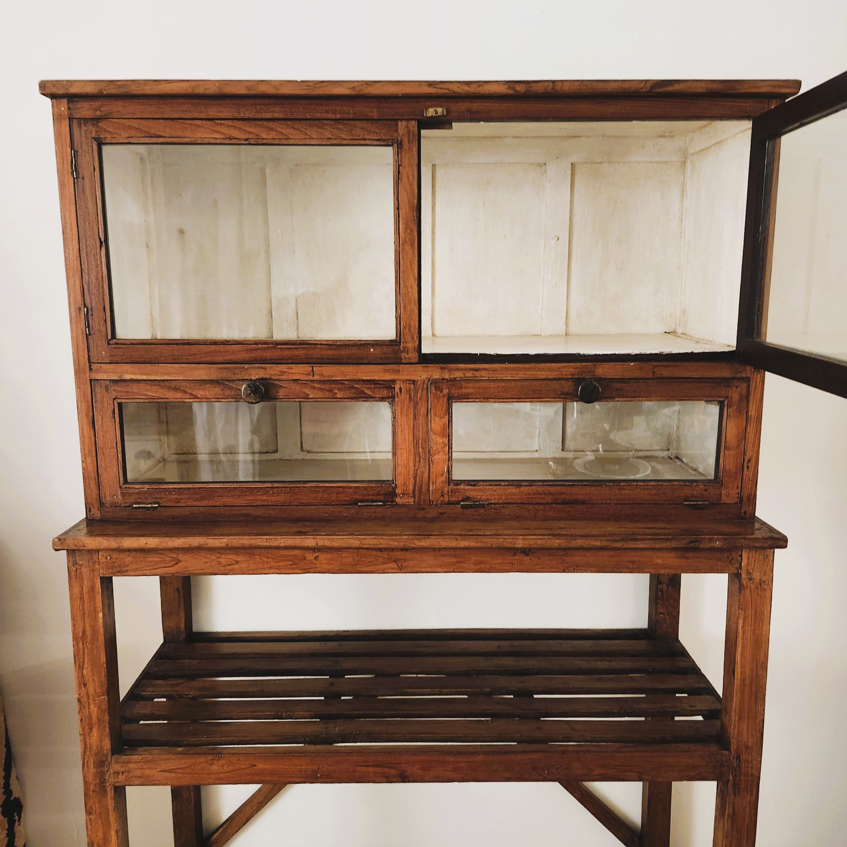 Vintage teak cabinet with glass doors and shelves, detail