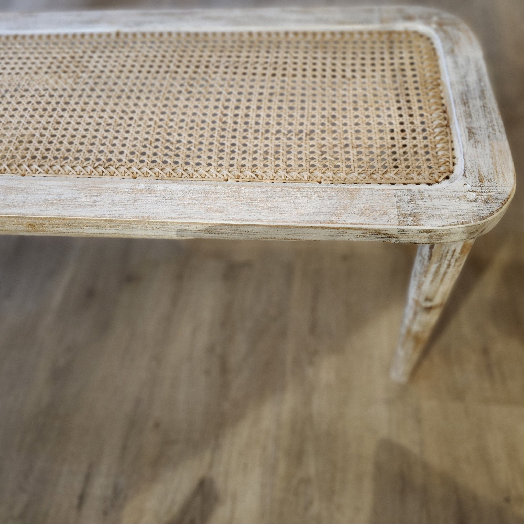 Cane-top bench with fluted legs and a limed finish