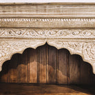 Teak bookcase with carved panel, side view