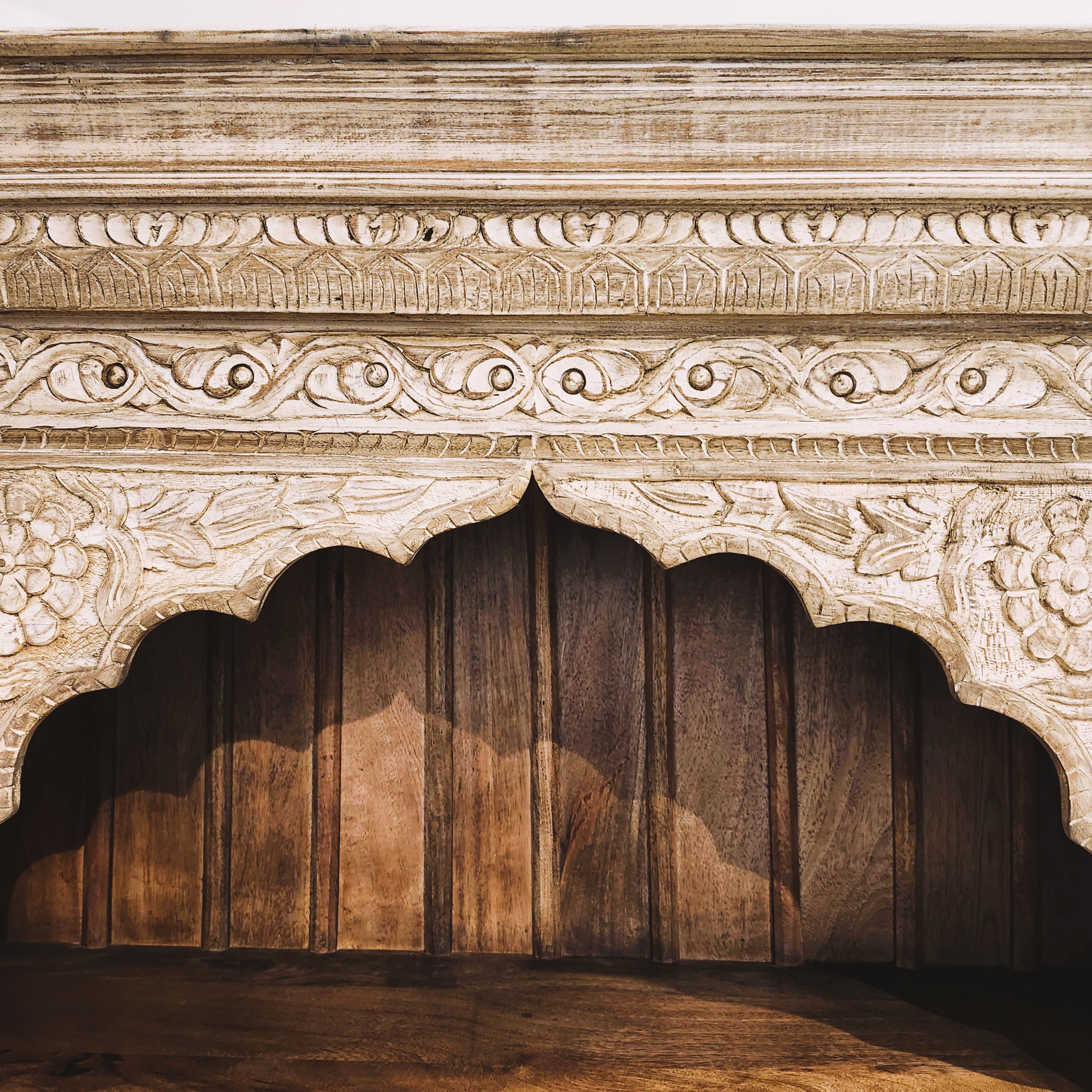 Teak bookcase with carved panel, side view
