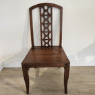 Vintage teak chair with geometric carving and cushion, styled
