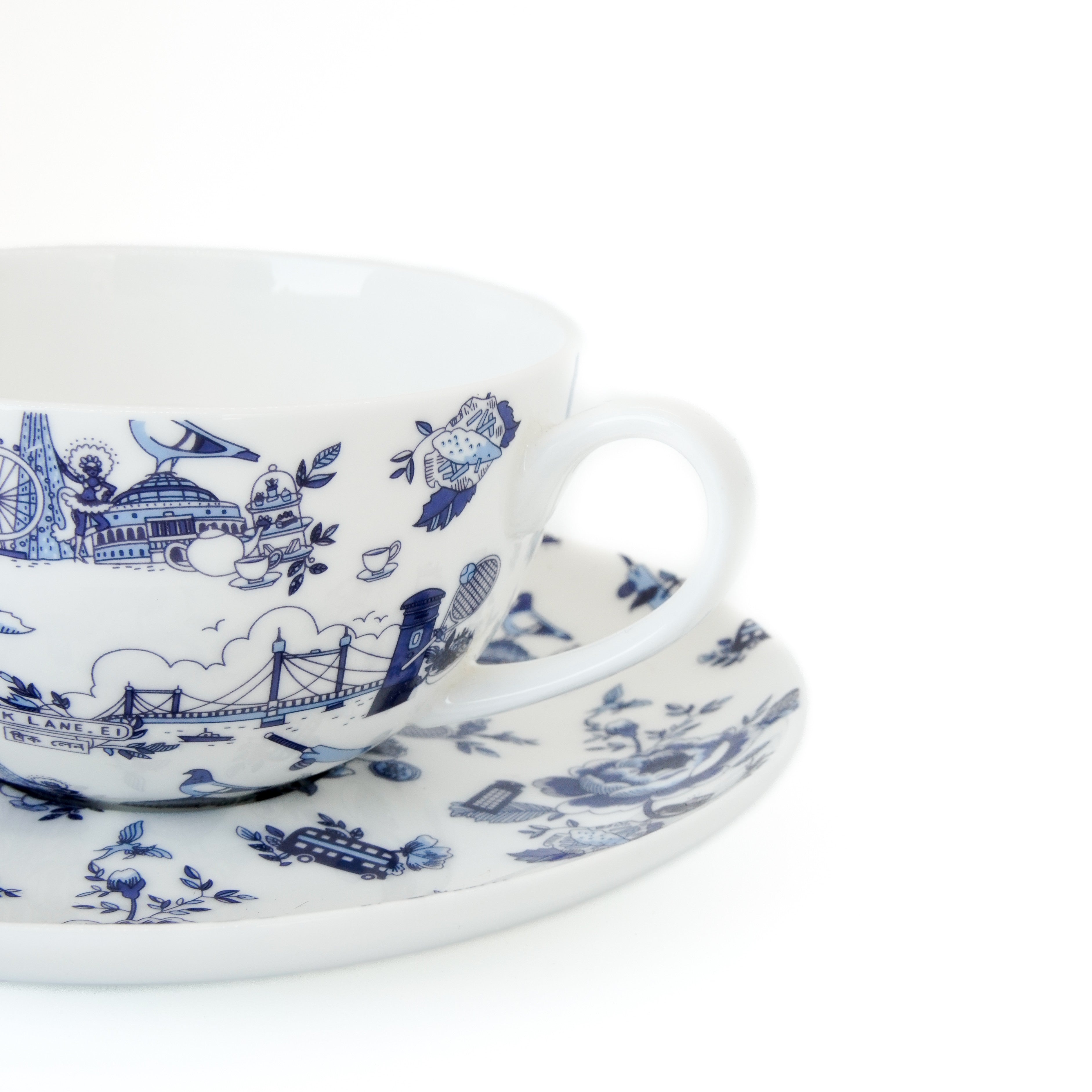 London Toile ceramic cup and saucer with blue intricate patterns on a white background
