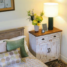 Green lacquer table lamp with white drum shade, styled in a room