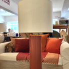 Lacquer table lamp with deep lustrous finish and white drum shade