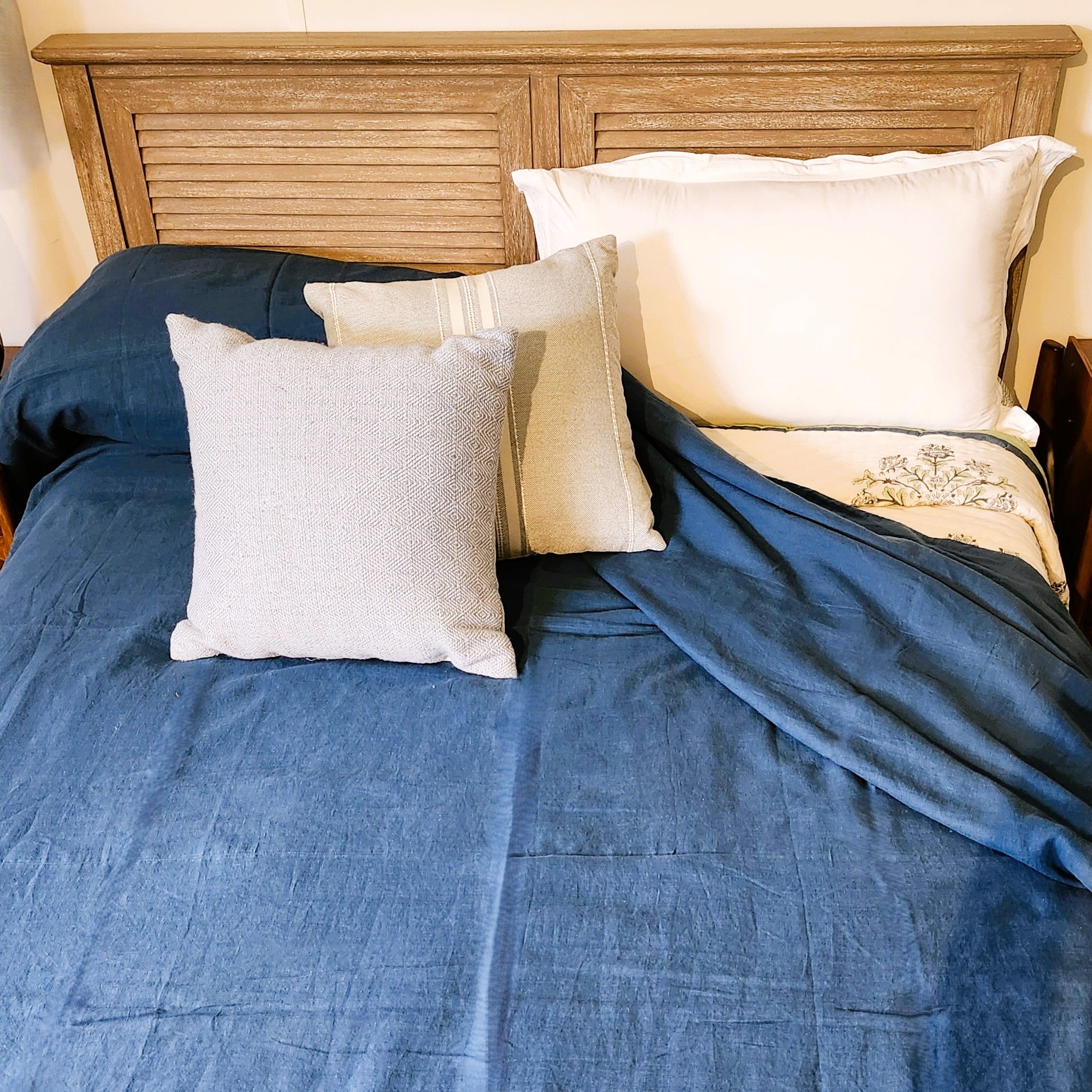 Sea linen bedspread in blue indigo, styled on a bed, detail
