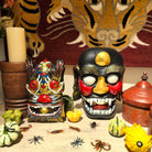 Hand-painted wooden Halloween masks, hung on a wall