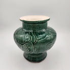 Jade Fish candle, green vase with fish design, styled view