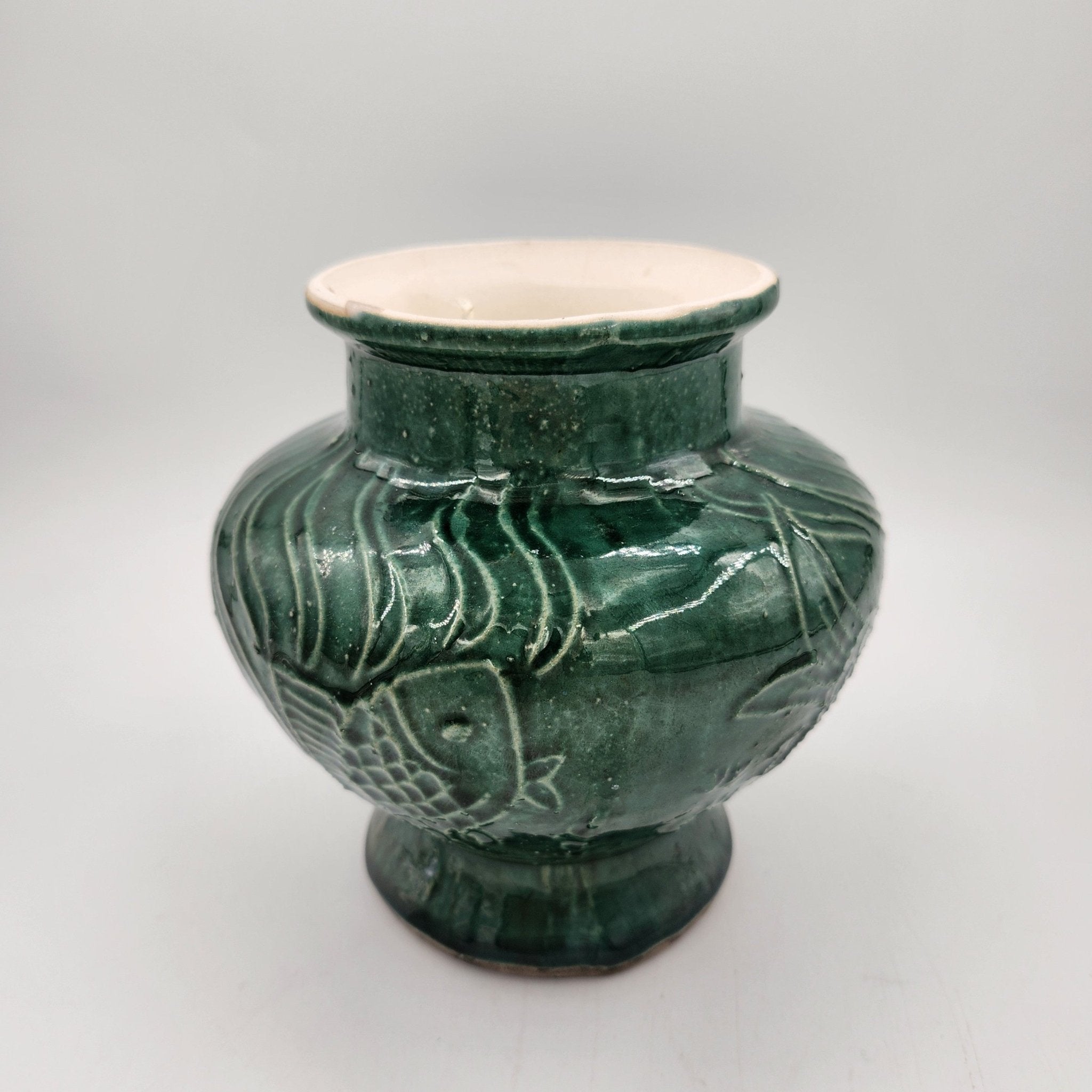 Jade Fish candle, green vase with fish design, styled view
