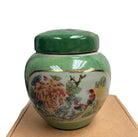 Birds and Flowers candle, green lidded ceramic jar, styled view
