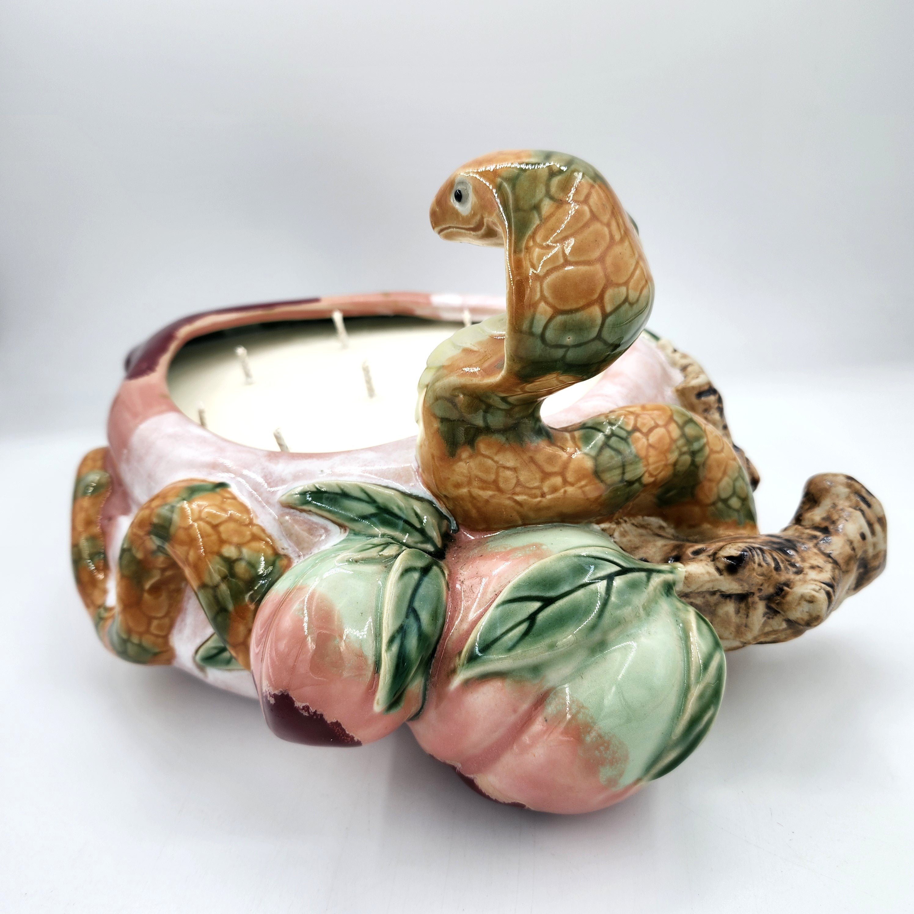 Legend candle, eight-wick ceramic jar with snake and peach motif, detail