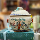 A Journey Begins soy wax candle in painted ceramic jar, styled view