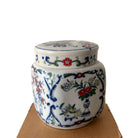 Vases with Flowers candle, floral-painted lidded pot, styled view