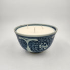 Ceramic rice bowl with decorative blue lotus pattern on a white background