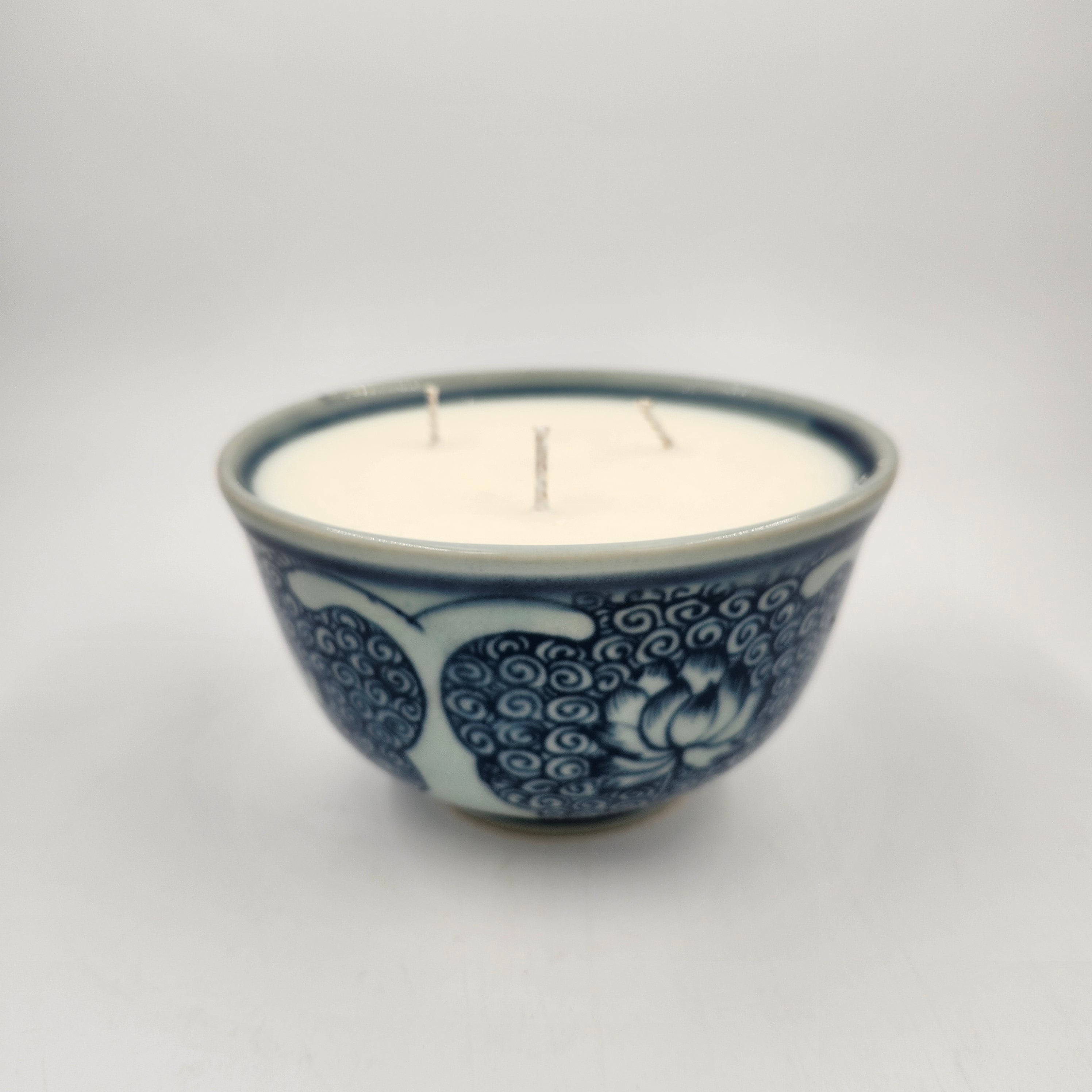 Ceramic rice bowl with decorative blue lotus pattern on a white background