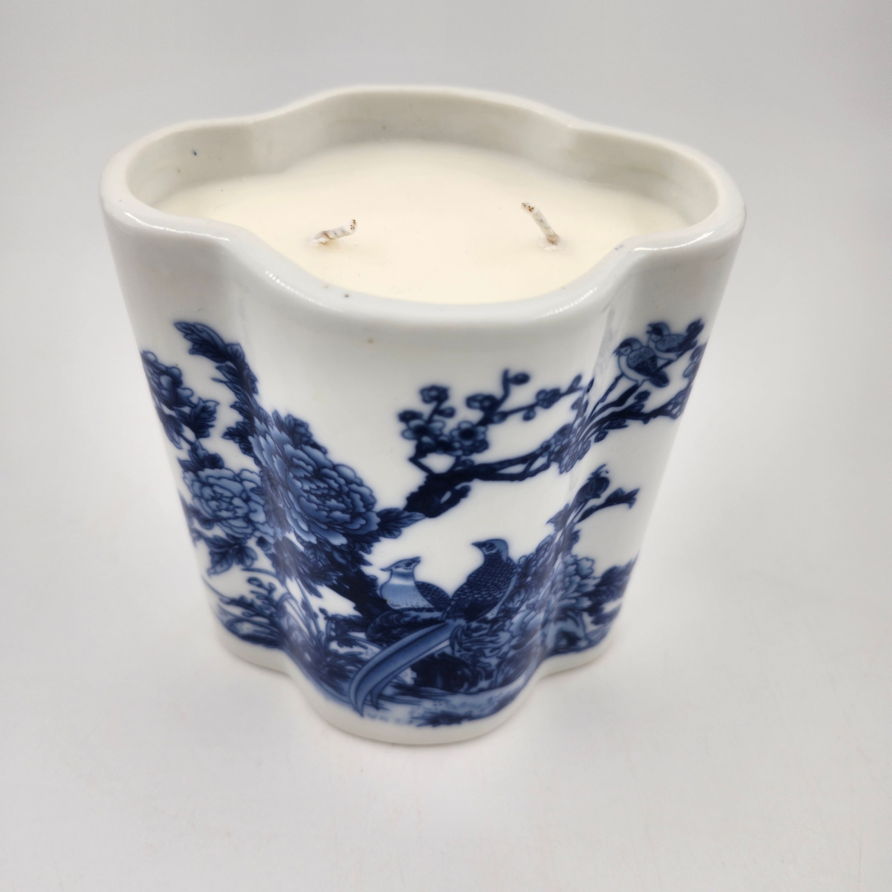 White ceramic scented candle with blue floral and bird pattern on a white background