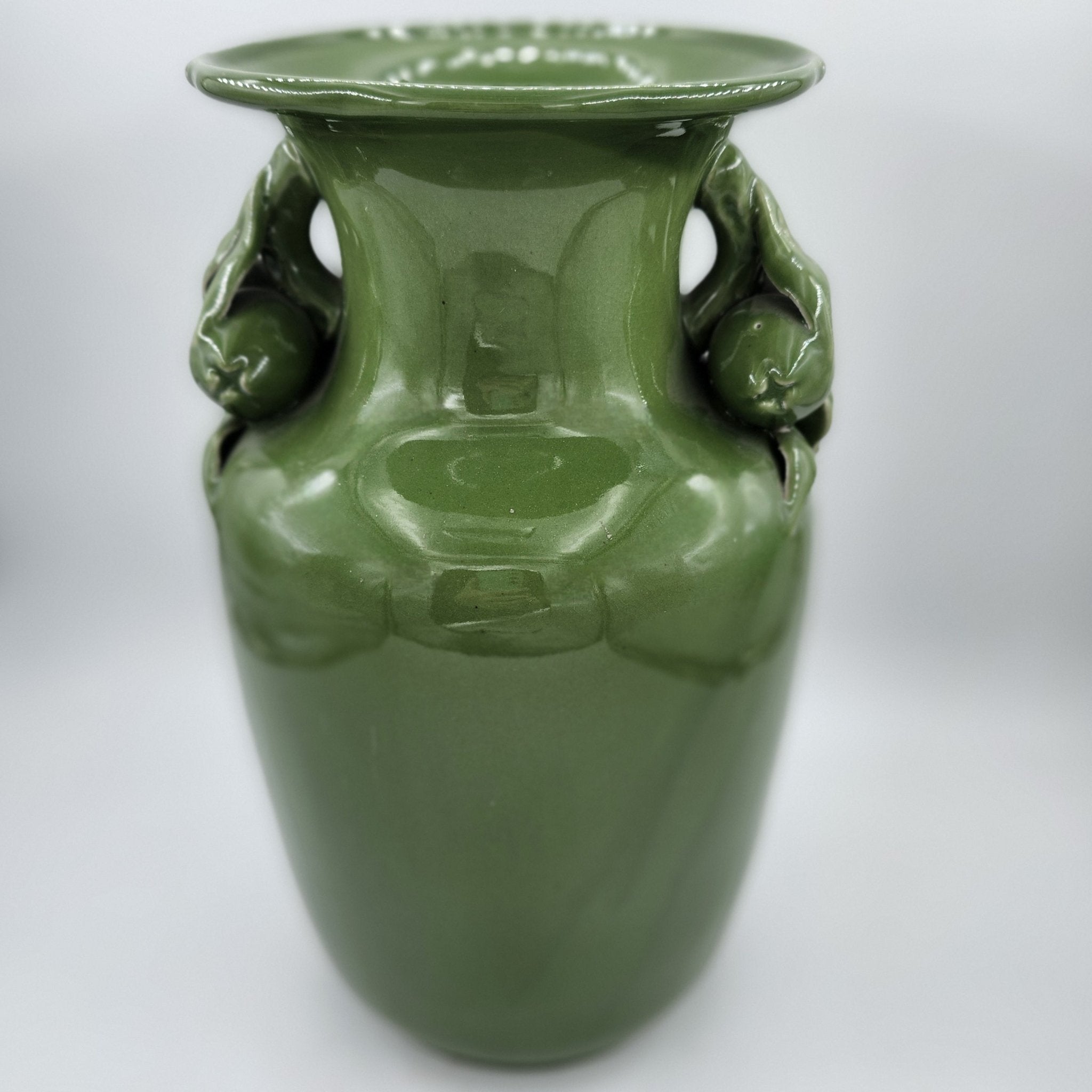 Vintage vase in plain green glaze with fruit and flower neck detail, 32cm high