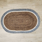 Oval woven jute door mat with brown centre and teal border, 80 x 49 cm