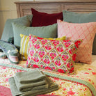 Suzani Gulestaan linen cushion in red, dusty pink and green, hand embroidered, 35 x 50cm