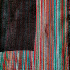 Multi striped pashmina silk shawl in charcoal, one side block colour with a multi striped border, reversed on the other
