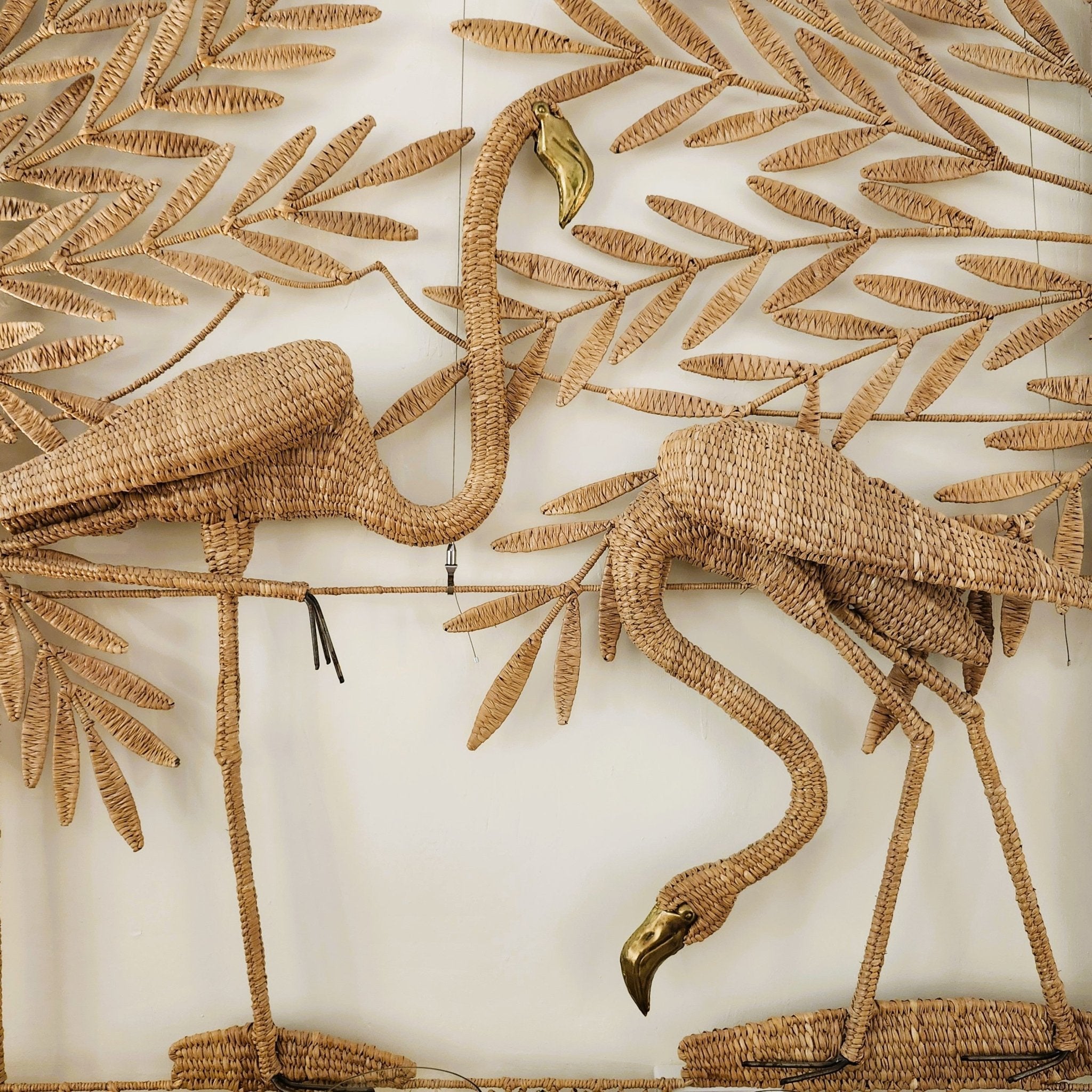 Flamingo screen by Maria Lopez Torres, rattan and brass with two flamingos on a palm background