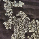 Close-up of silver birds of paradise block print on black voile