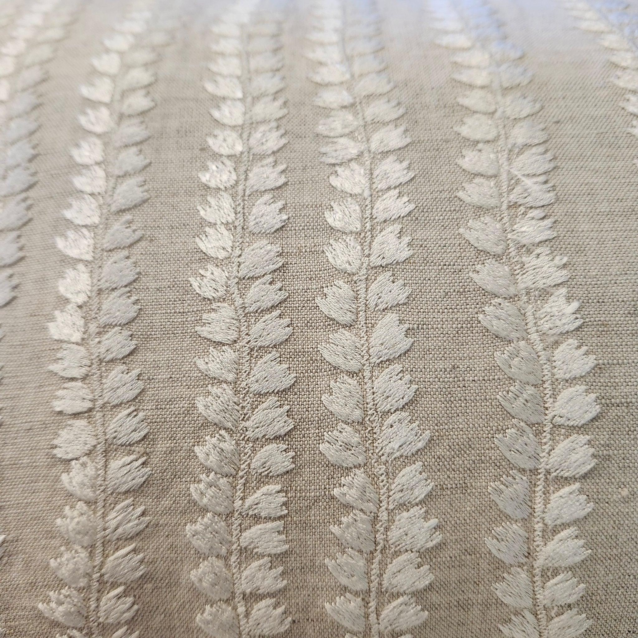 Natural Beige embroidered cushion detail showing white floral embroidery on cotton linen, 30 x 46 cm