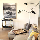 Serge Mouille floor lamp in painted black steel with three pivoting arms and brass joints