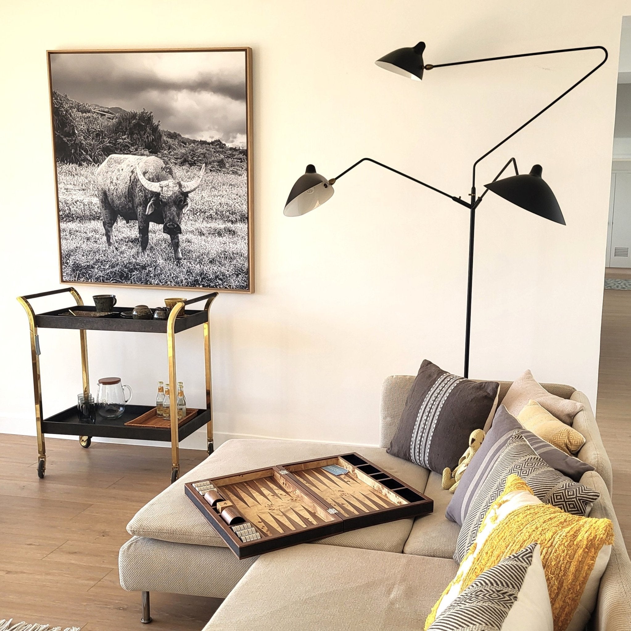 Serge Mouille floor lamp in painted black steel with three pivoting arms and brass joints
