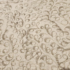 Natural cotton linen table runner machine embroidered with an intricate swirl design, cotton satin reverse, 40cm wide