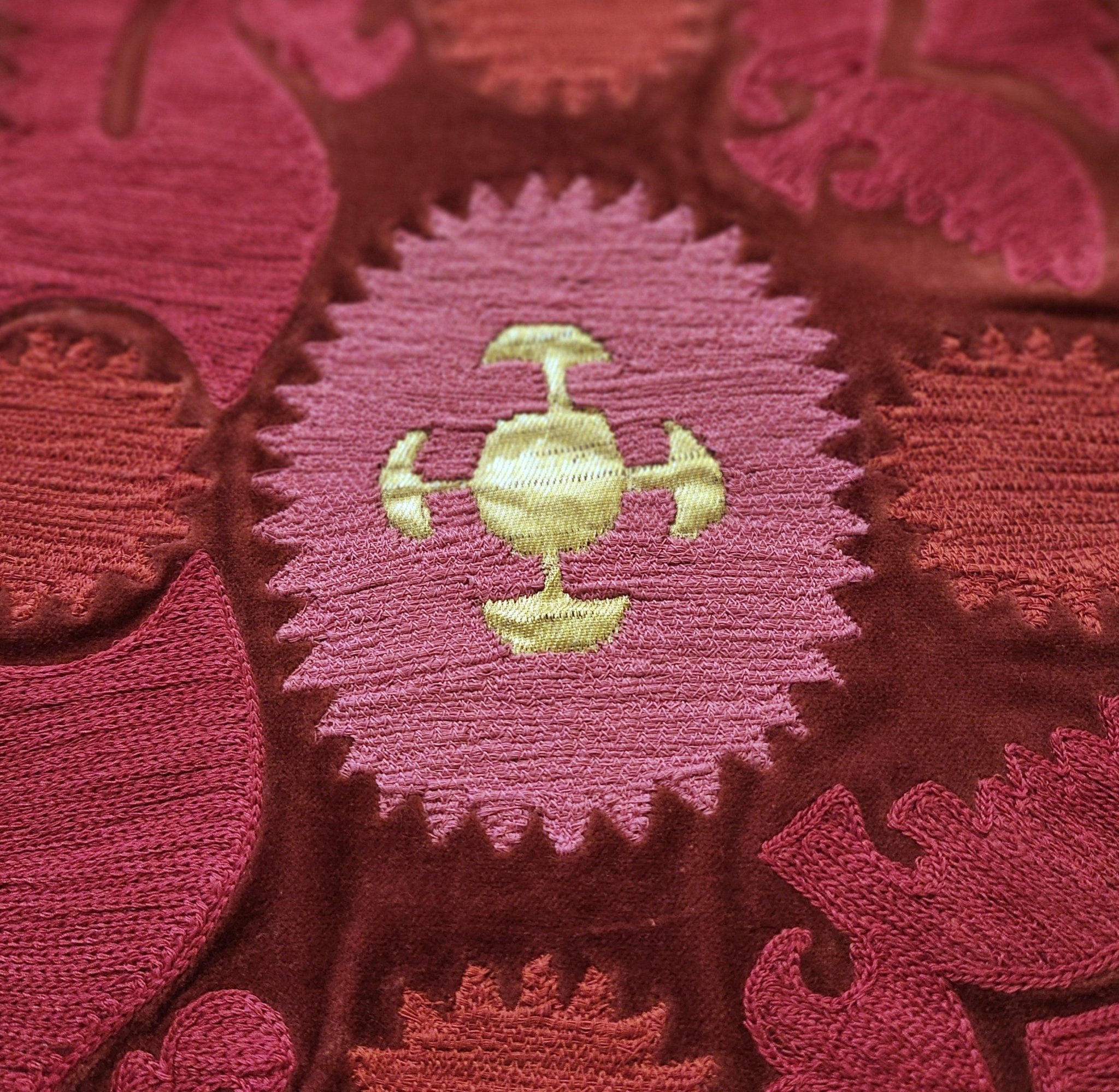 Detail of the Bodum cushion, hand embroidered in India in red, pink and gold on cotton velvet.