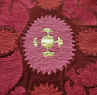 Detail of the Bodum cushion, hand embroidered in India in red, pink and gold on cotton velvet.