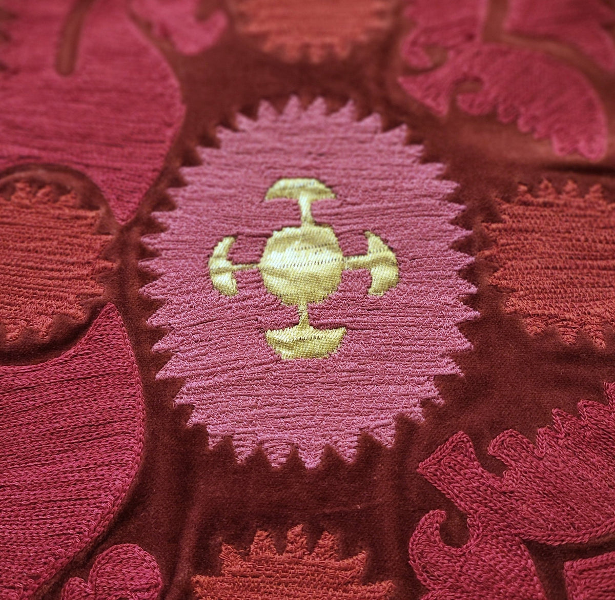 Detail of the Bodum cushion, hand embroidered in India in red, pink and gold on cotton velvet.