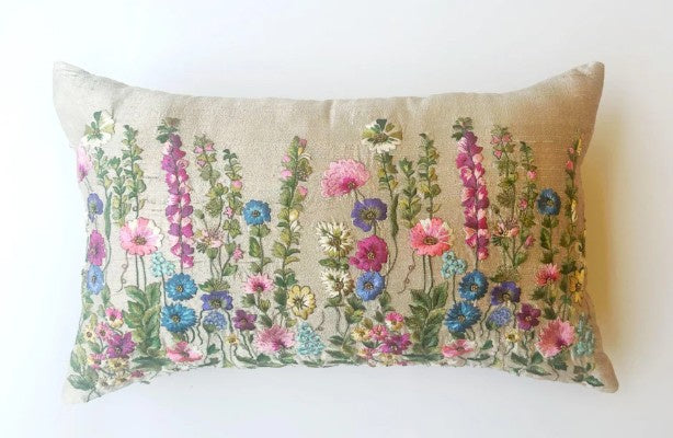 Cushion embroidered with wild flowers.