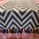Linen table runner with plain and chocolate chevron stripes stitched together, hand-crafted tassels in several colours
