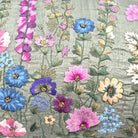 Embroidered cushion with colorful floral pattern on a green raw silk background