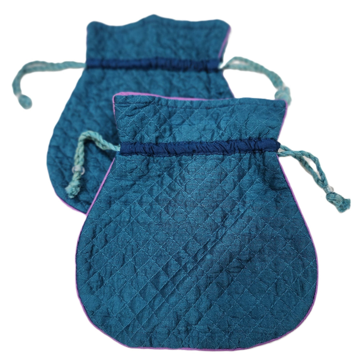 Detail of a quilted pure silk pouch, showing the pink silk lining and its string closure.