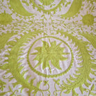 Hand embroidered suzani throw in lime green on cream background