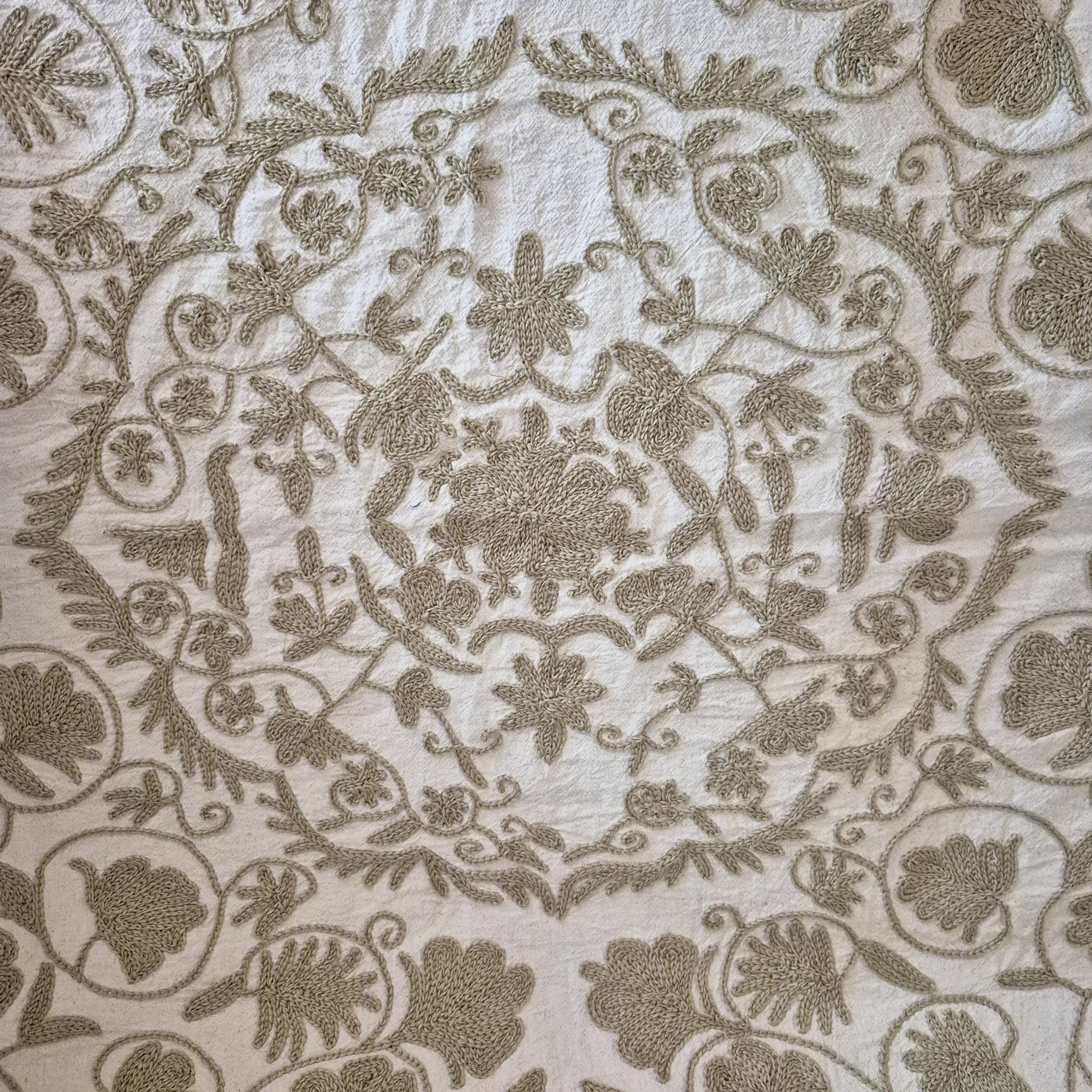 Hand Embroidered suzani in beige on a cream background