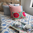 Suzani Fergana linen cushion, turquoise, pink and red, detail