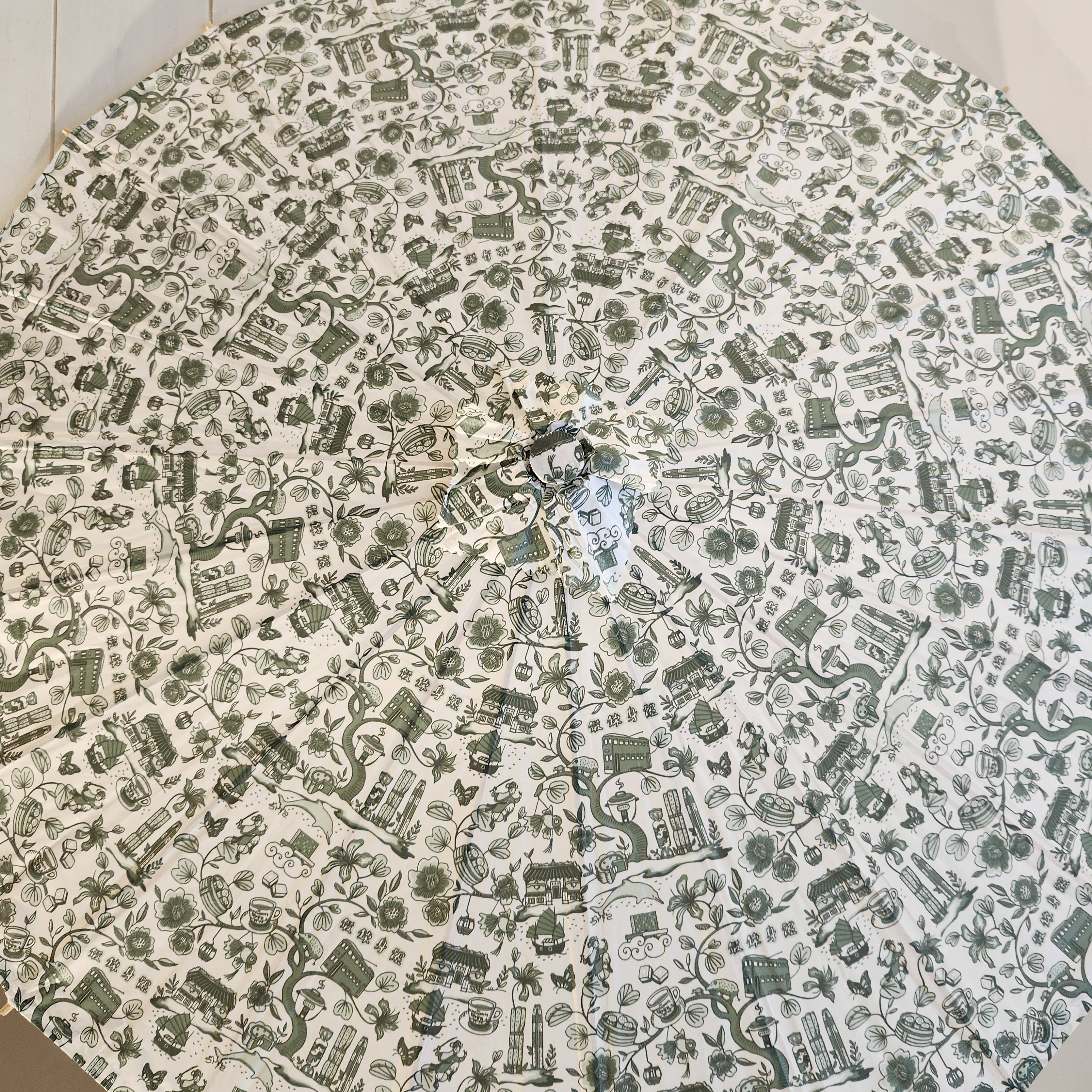 Hong Kong Toile paper parasol in green and white, printed paper on wooden frame
