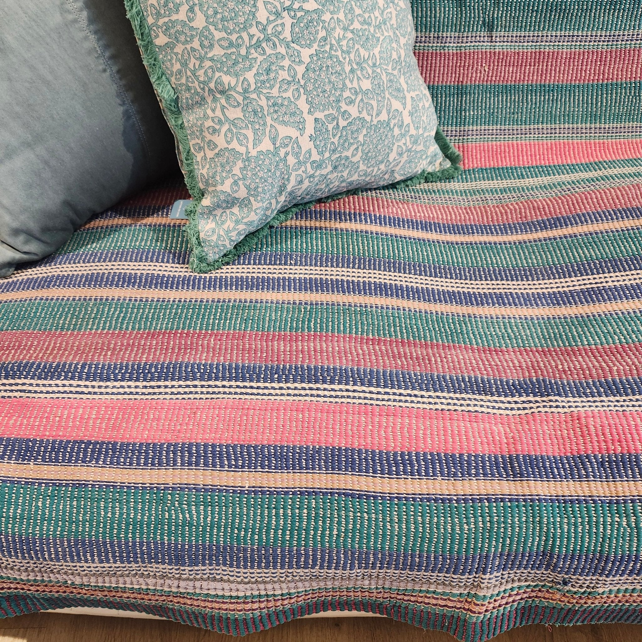 Vintage kantha quilt in pastel stripes, draped