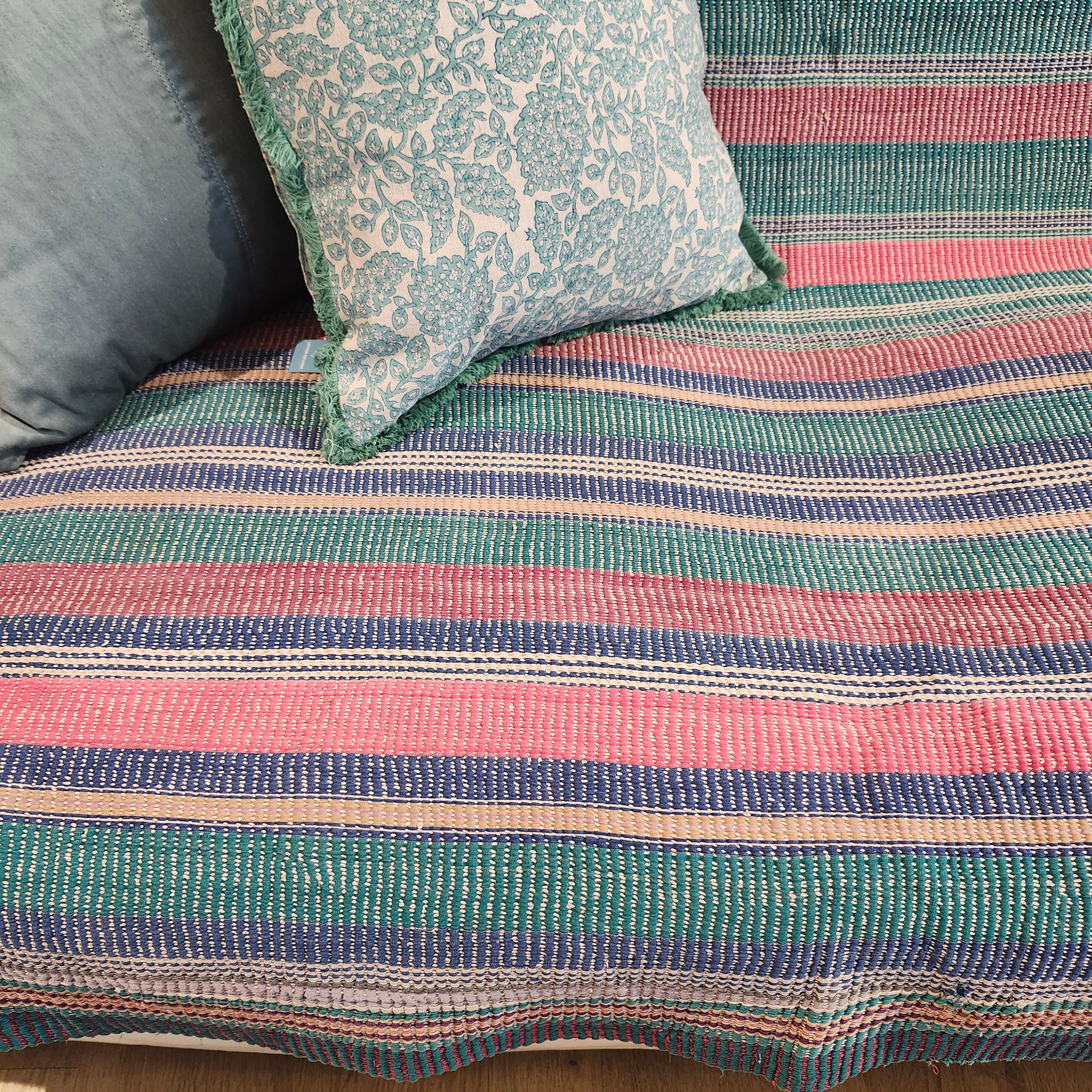 Vintage kantha quilt in pastel stripes, draped